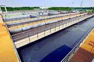 Water treatment facility with FRP drainage channels and plant access covers.